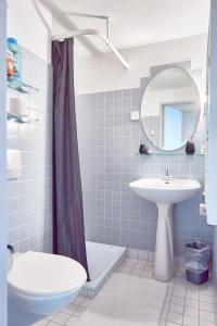a bathroom with a sink and a toilet and a mirror at Doppelzimmer mit Terrasse in Därligen