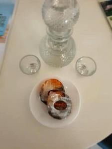 a plate of food on a table with a glass vase at Damianakis Village Rethymno in Somatás