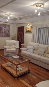 a living room with two couches and a coffee table at Casa Pampa in Sarmiento