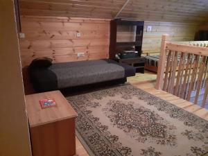 a bedroom with a bed in a room with a rug at Rauhallinen mökki in Lahti