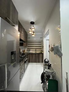 a kitchen with stainless steel appliances and wooden cabinets at Onelove Homes in Lusaka