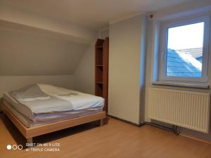 a small bedroom with a bed and a window at Nice small house in beautiful Carinthia in Feistritz im Rosental