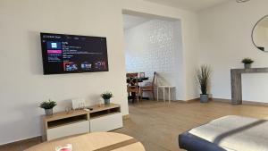 a living room with a tv on the wall at STAY Sky Apartment in Limassol