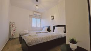 a bedroom with two beds and a window at STAY Sky Apartment in Limassol
