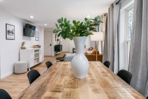 a white vase on a wooden table in a living room at Cozy Home in Downtown McKinney with Backyard in McKinney