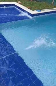 a large blue swimming pool with blue water at Cabañas Alpinas in San Bernardino