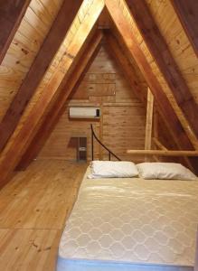 a room with a bed in a attic at Cabañas Alpinas in San Bernardino