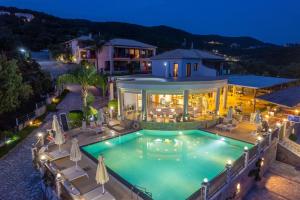an aerial view of a house with a swimming pool at 3Aktes Suites & Studios in Syvota