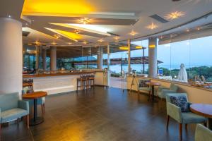 a restaurant with a bar with a view of the ocean at 3Aktes Suites & Studios in Syvota