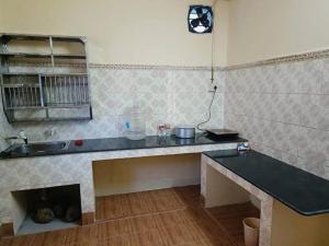 a kitchen with a counter top and a sink at Sea Edge Homestay in Port Blair