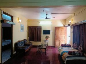 a living room with a couch and a table at Sea Edge Homestay in Port Blair