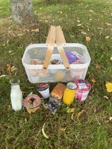 a basket full of food and other items on the grass at Whitemoss Lodge in Dunning