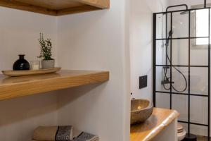 a kitchen with a counter with a bowl on a shelf at Raffar luxury houses in Tinos Town +94 photos