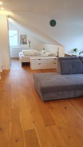 a living room with a couch and a bed at Weitblick Ferienwohnung in Offenburg