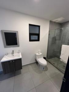 a bathroom with a toilet and a sink and a shower at Apartment in Tijuana in Tijuana