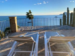 two chairs sitting on the beach near the ocean at El jardin Botánico Villa LUZ in Altea