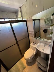 a bathroom with a toilet and a sink at Mary's House in Libertad