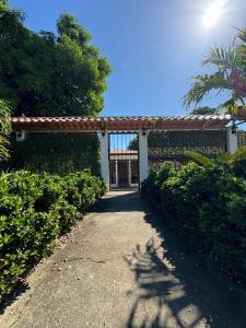 a pathway leading to a building with a gate at Mary's House in Libertad