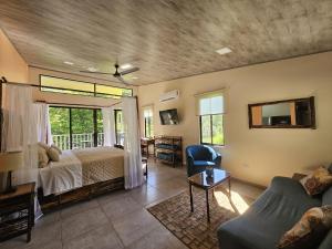 a bedroom with a bed and a couch at CASITAS SELVARA in Platanillo