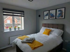 a bedroom with a bed and a window at 2 Bedroom Apartment in Exhall