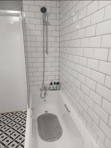 a bathroom with a shower with a bath tub with a drain at 2 Bedroom Apartment in Exhall