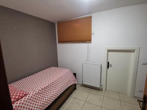 Habitación pequeña con cama y ventana en Appartamento Mercantini, en Monsampolo del Tronto