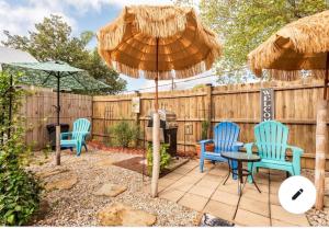 a patio with two chairs and a table with an umbrella at The Guest Room in Abbeville