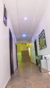 a hallway with a staircase with green and yellow walls at Water Ripples Hotel Lekki in Lekki