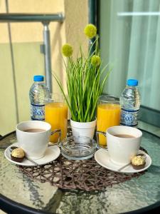 a table with two cups of coffee and glasses of orange juice at Sunshine Beach Studio in St. St. Constantine and Helena