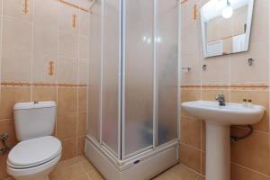 a bathroom with a shower and a toilet and a sink at Lale Apartments Fethiye in Fethiye