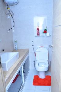 a bathroom with a white toilet and a sink at F3 Dakar Plateau Appartement Cité Emmergence in Dakar