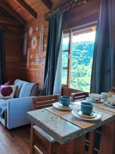 a living room with a table and a couch at Pousada Hoff Haus in Pomerode