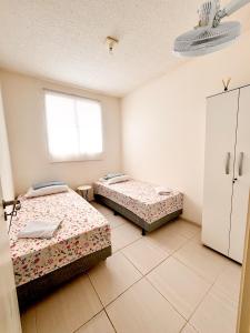 A bed or beds in a room at Apê Residencial Mangueiras