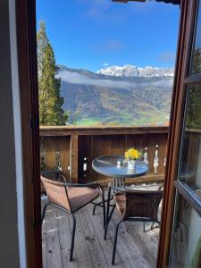 a patio with a table and chairs on a deck at Apartment Sabrina in Sankt Johann im Pongau