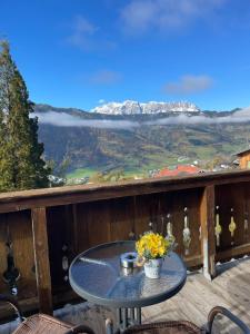 a table on a deck with a view of a mountain at Apartment Sabrina in Sankt Johann im Pongau