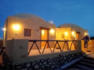 a man standing on the balcony of a house at WAFLA in Siwa