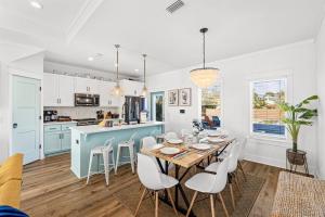a kitchen and dining room with a table and chairs at Sand Castle in Panama City Beach