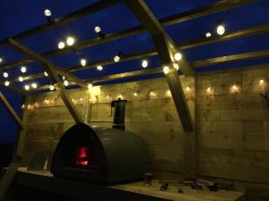 a brick oven with lights on the wall at Easter Ellister in Port Charlotte