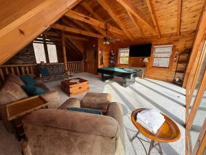 a living room with a pool table in a cabin at Smoky Paws - Exceptional Cabin, Stunning Mountain Views, Hot Tub, Tranquil, Gigabit Internet, Free L2 EV in Pigeon Forge +21 photos