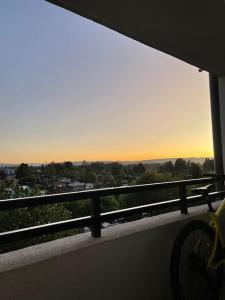 a view of a city from a balcony with a bike at Departamento céntrico in Valdivia