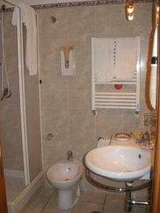 uma casa de banho com um lavatório e um WC em Hotel Lento em Melito di Napoli