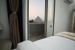 Voodi või voodid majutusasutuse Capital Of Pyramids Hotel toas
