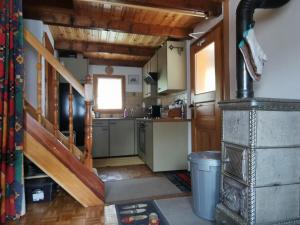 a kitchen with a staircase and a stove in a room at Chalet Dixence in Hérémence