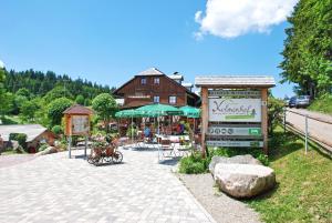 a building with a sign in front of a house at Der Kolmenhof - Dein Ort an der Quelle in Furtwangen