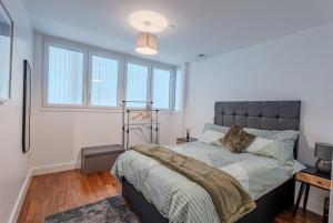 a bedroom with a bed with a large window at Metropolitan House, 1 Hagley Road in Birmingham