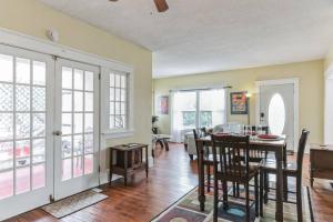 a living room with a table and a dining room at Beautiful Home Steps from the beach + Side Porch in Daytona Beach