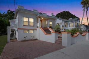 a large white house with a brick driveway at Beautiful Home Steps from the beach + Side Porch in Daytona Beach