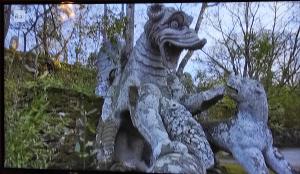 a statue of a dragon with four pigeons at Palazzo Verdi Holiday Viterbo in Viterbo