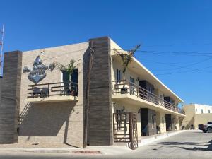 a building on the side of a street at Urban Hotel El Ancla Suites - Apartment 3 in Puerto Peñasco