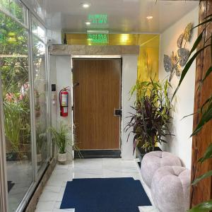 a lobby with a door with a sign that says exit at Calu L' Petit Hostel in Quito